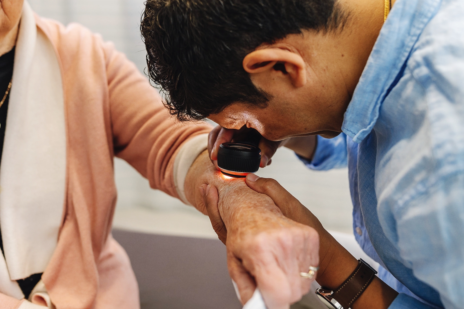 Dr Shrestha performing a dermoscopy skin check on a patient